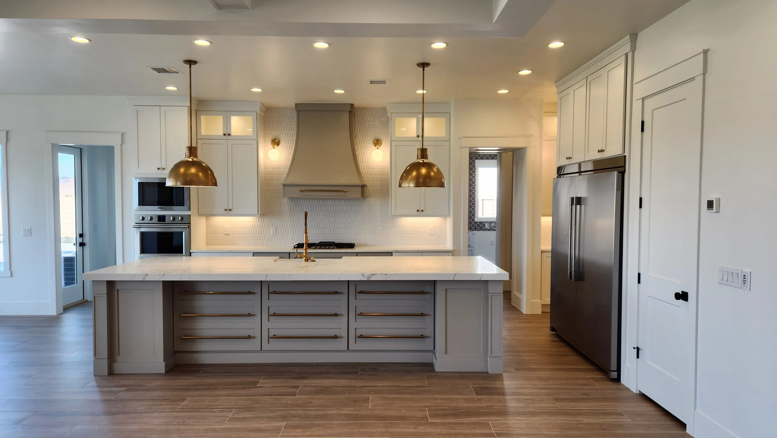A refined kitchen with a black hood and brass trim — a VA-loan home for those who served.